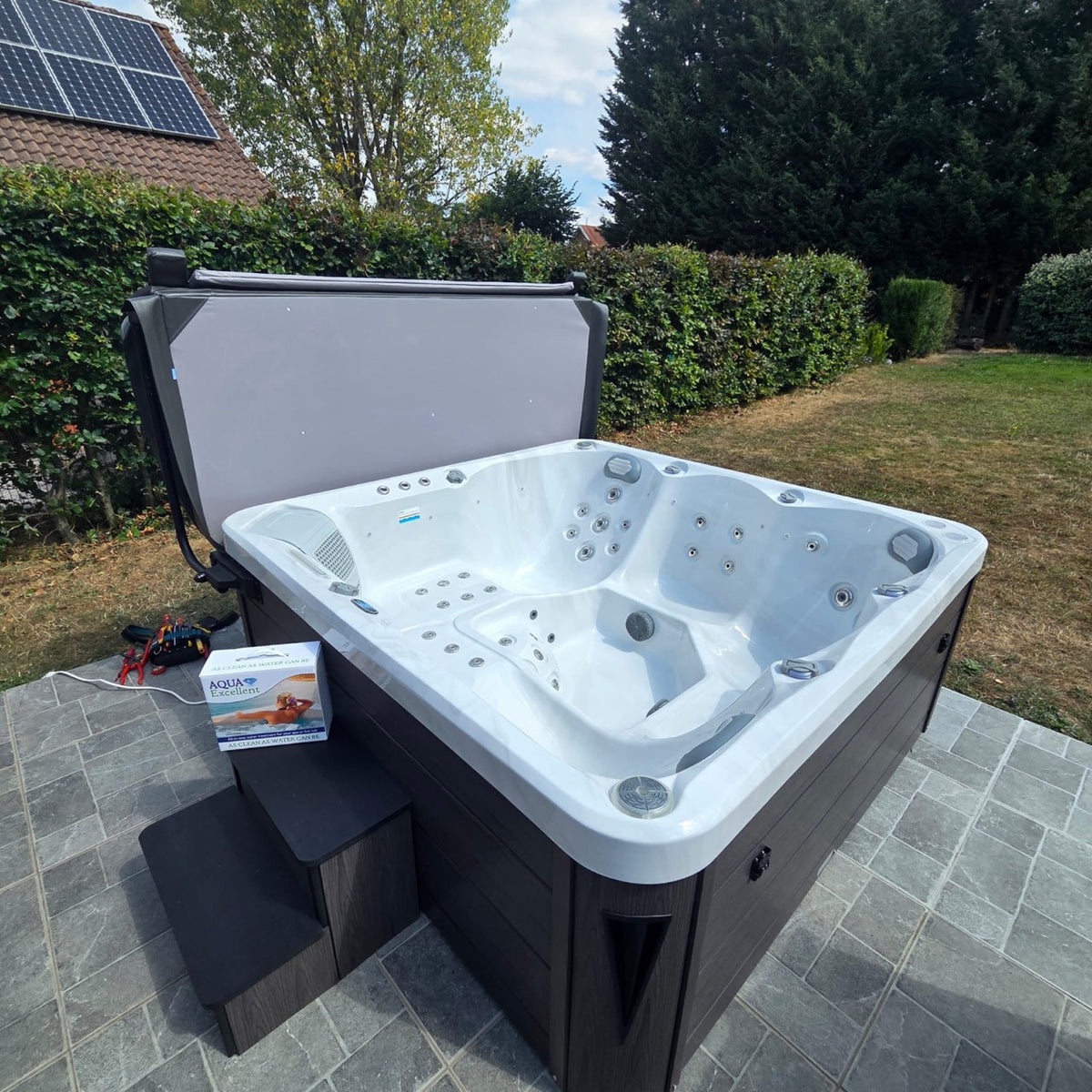 Spa blanc installé au bord d’un jardin